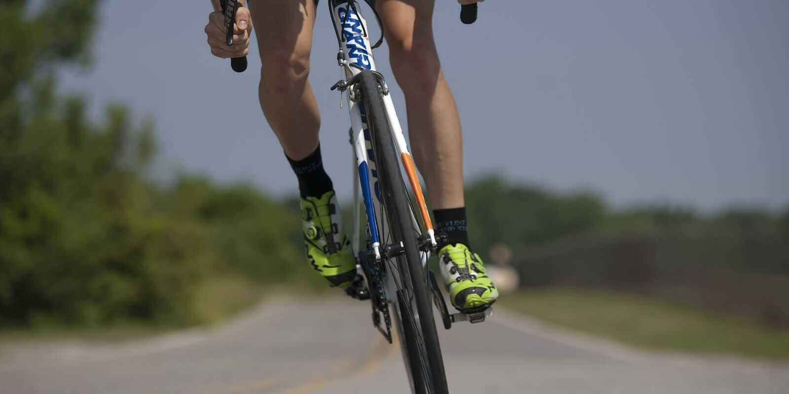 Close up of the feet of a man on a bike